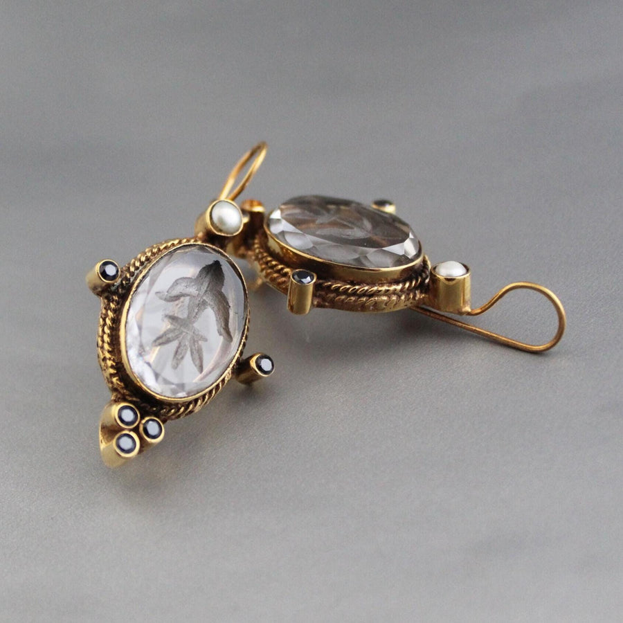 Clear oval intaglio earrings with a carved Roman profile