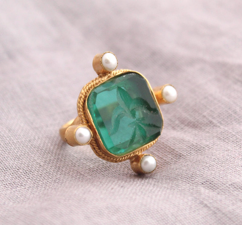 Green intaglio cocktail ring in a Roman style gold setting