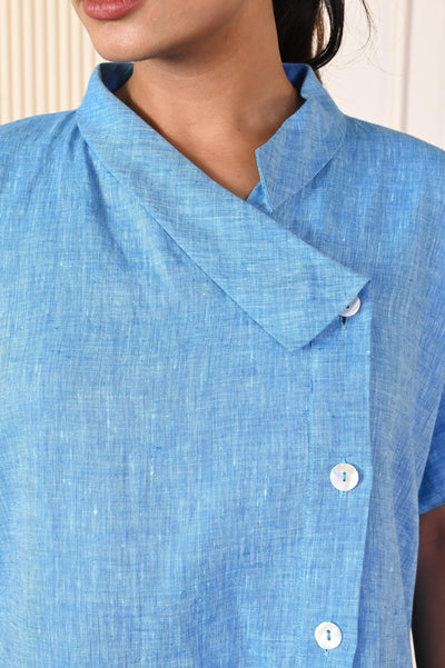 A-Line Collared Midi Dress: close-up of asymmetric collar and buttons on light blue linen dress