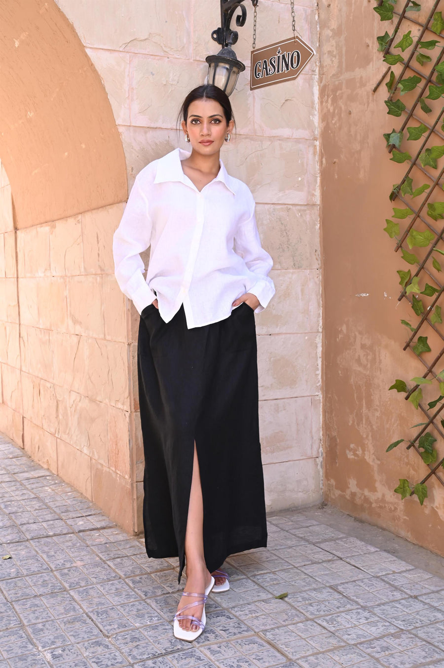 Black Linen Maxi Skirt with Slit: woman in white shirt and Black maxi skirt, hand in pocket, full length