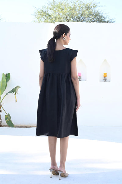 Black Linen Midi Dress with Ruffle Trim: back view of black linen midi dress with ruffle cap sleeves