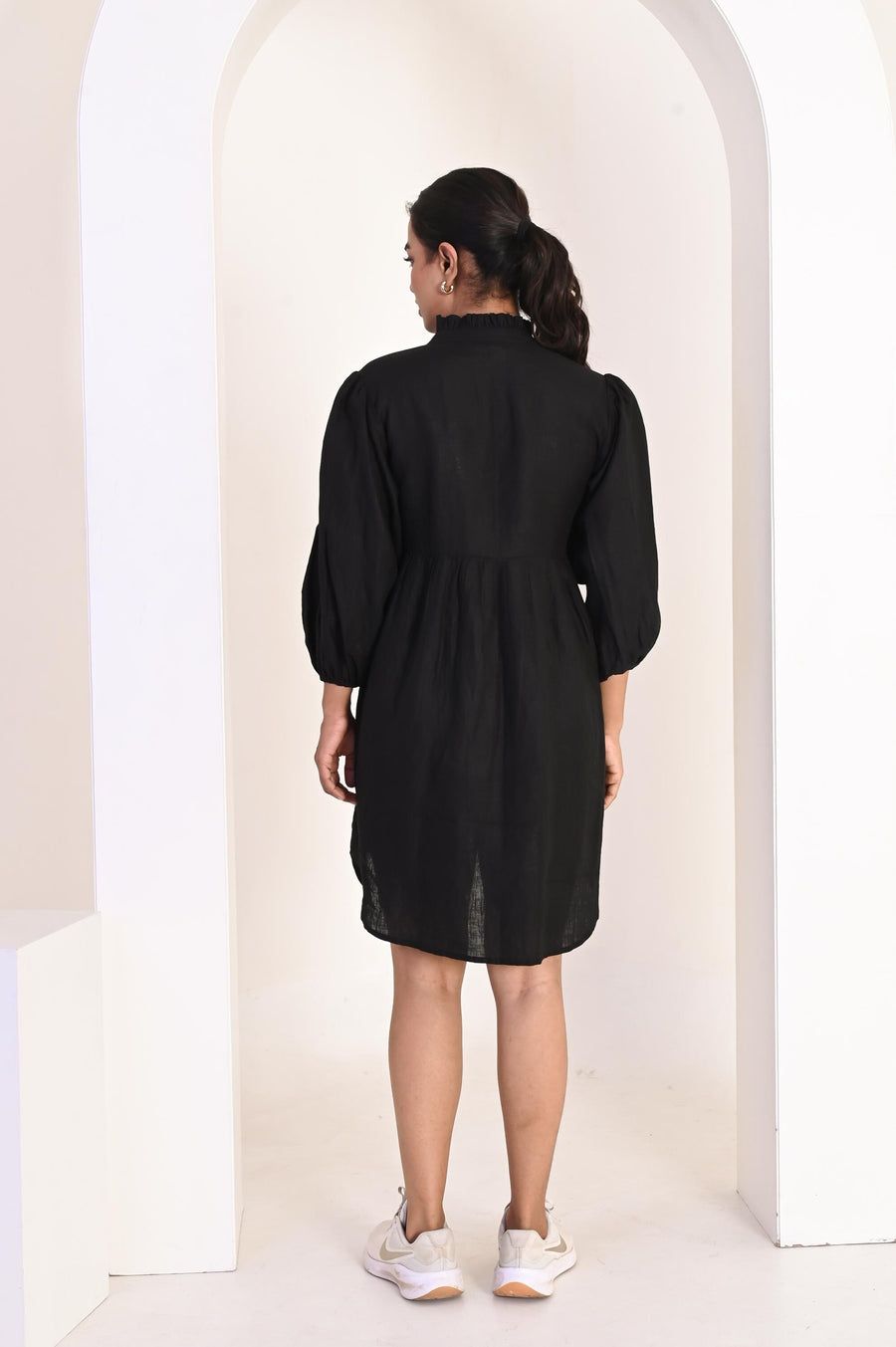 Black Ruffle V-Neck Linen Mini Dress: back view of black ruffle linen mini dress with puff sleeves