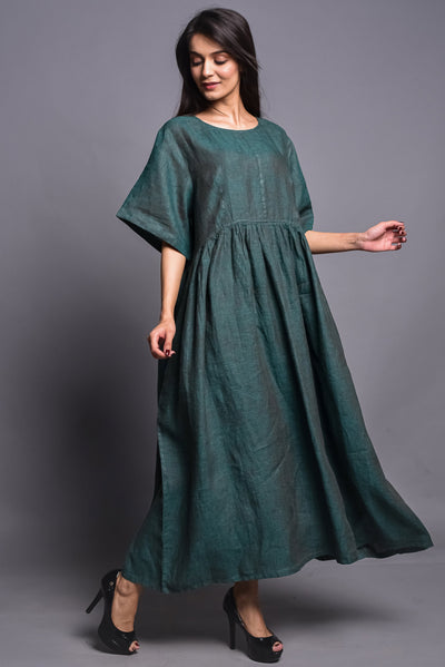 Bohemian Linen Maxi Dress: walking pose in Deep Green maxi dress, three-quarter view