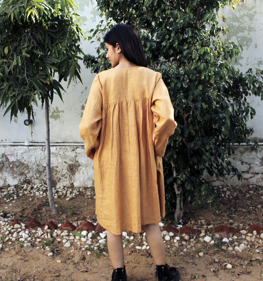 Cottagecore Linen Midi Dress: back view of mustard linen midi dress with gathered yoke