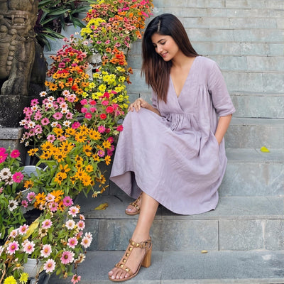 Flax Linen A-Line Empire Waist Dress: seated on flower steps in Lavender dress, looking to the side