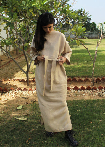 Handmade Maternity Linen Belt: woman in beige long dress wearing a tied linen belt in a garden