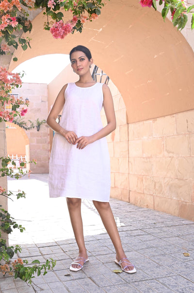 Handmade White Linen Tunic Dress: woman in White linen tunic dress with hands at her sides, standing in an arch