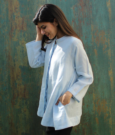 Light Blue Linen Tunic Top: woman in light blue tunic top, turned to side