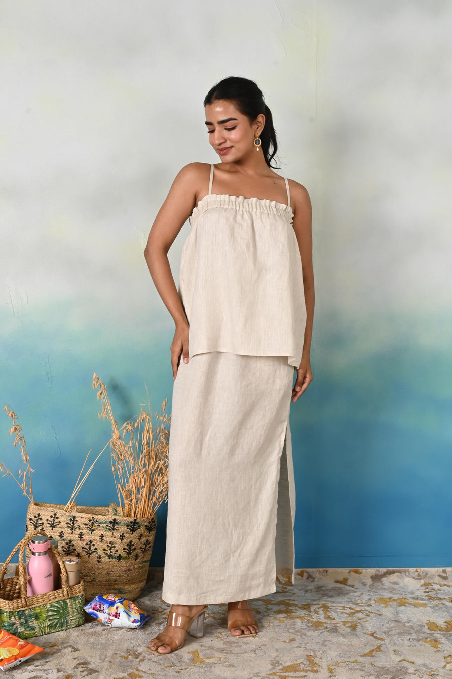 Linen Co-ord Set, Strappy Top & Maxi Skirt: woman in Natural linen strappy top, skirt with side slit, angled view