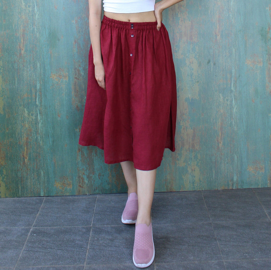 Linen Cotton Blend Midi Skirt, Flared A-Line: Garnet flared midi skirt, three quarter view, hands in pockets