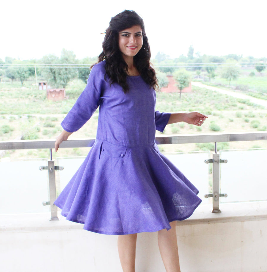 Linen Knee Length Party Dress, Circle Skirt: woman in violet linen dress with drop waist skirt, one arm out