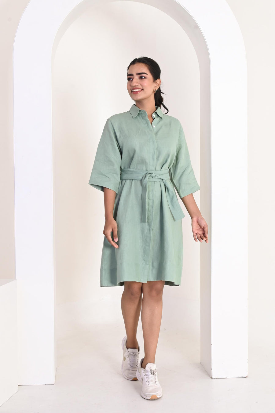 Linen Relaxed Fit Shirt Dress, Tie Belt: woman in Sage Green linen shirt dress with tie belt, front view under an arch