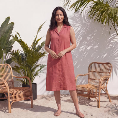 Linen Shirt Dress, Button-Up Long Sleeve: woman in Terracotta sleeveless shirt dress with notch collar by rattan chairs