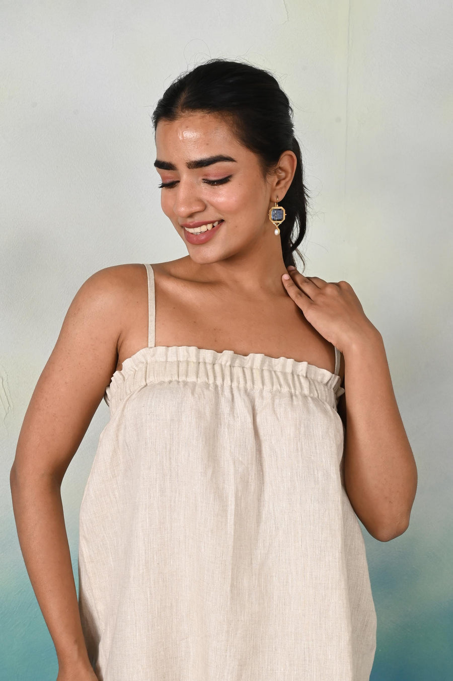 Linen Spaghetti Strap Top, Ruffle Tank: woman in Natural linen ruffle tank top looking down, smiling