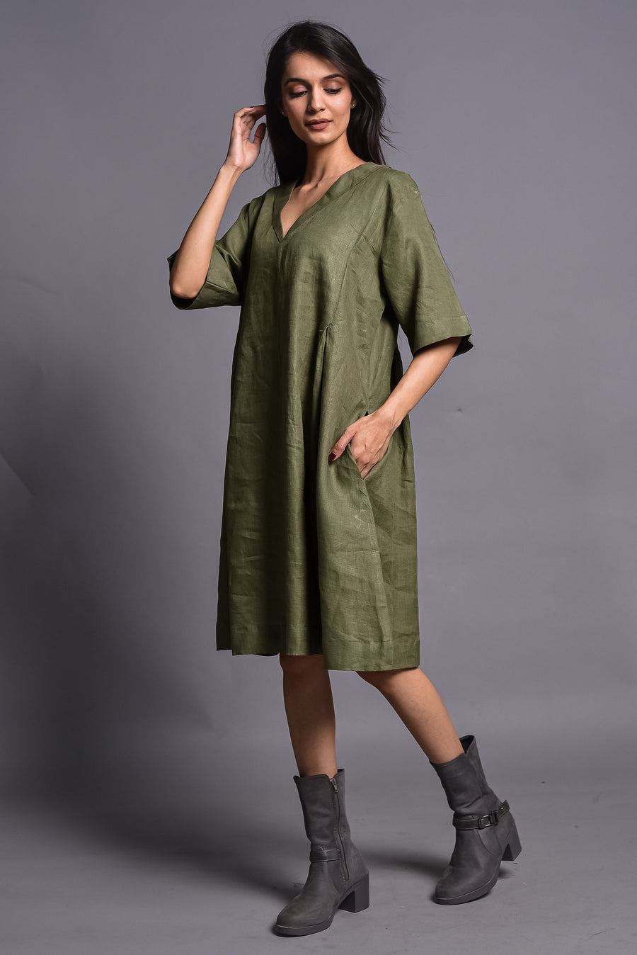 Linen Tunic Dress, V-Neck Half Sleeve: woman in moss green linen tunic dress, hand near face, three quarter view