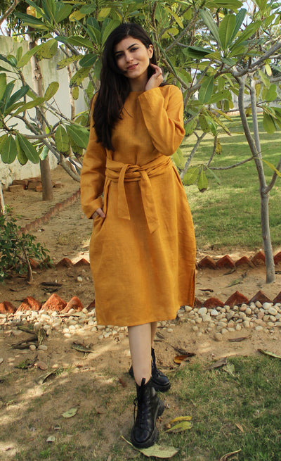 Long Sleeve Belted Linen Midi Dress: woman in Honey midi dress, standing in garden