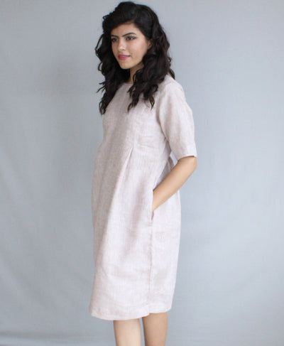 Loose Linen Midi Tunic Dress, Relaxed Fit: side view of pale blush linen tunic dress with hand in pocket
