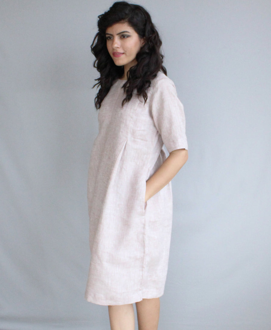 Loose Linen Midi Tunic Dress, Relaxed Fit: side view of pale blush linen tunic dress with hand in pocket