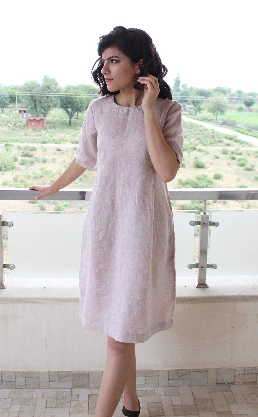 Loose Linen Midi Tunic Dress, Relaxed Fit: woman in pale blush linen tunic dress on a balcony, short sleeves
