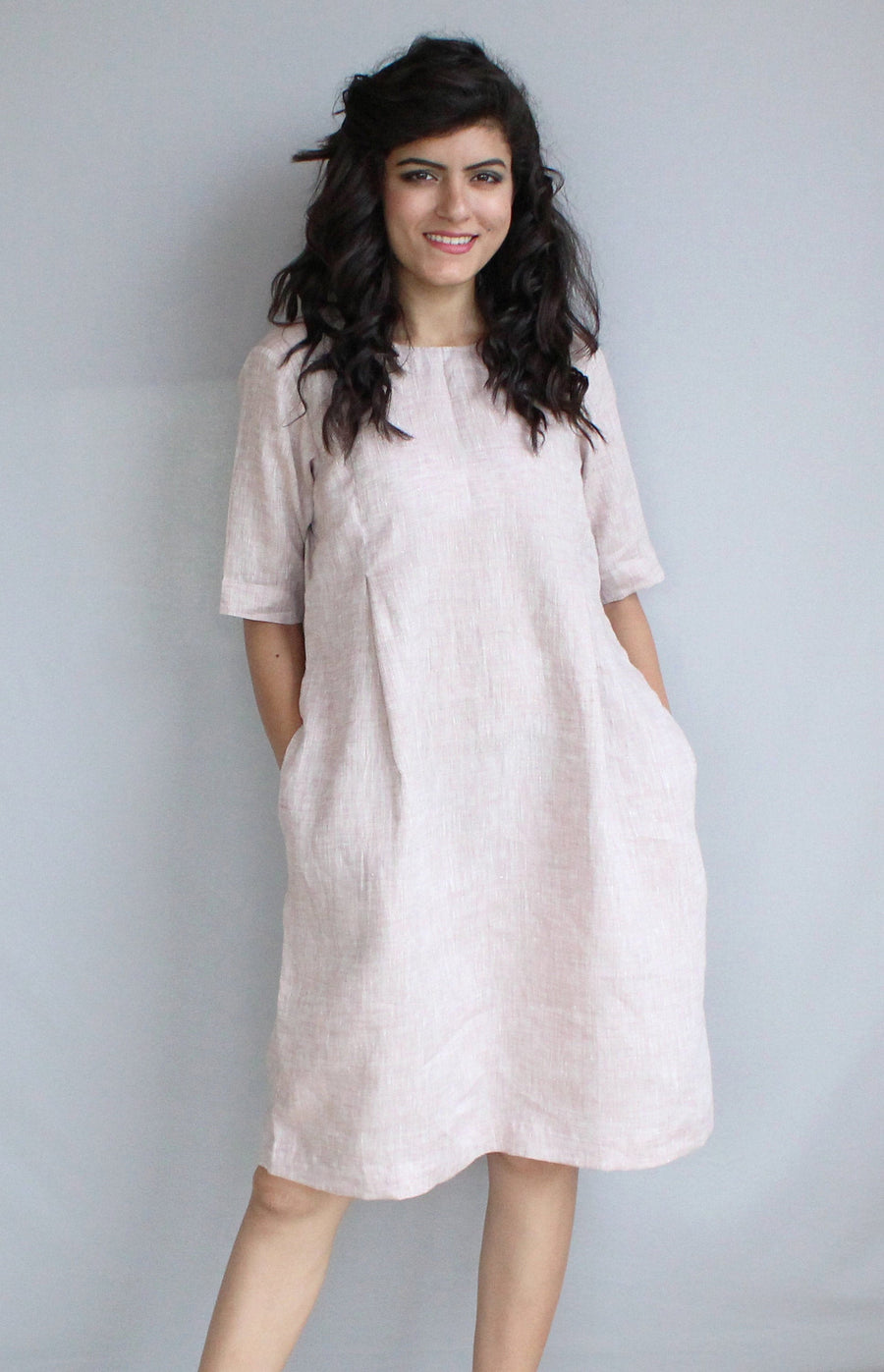 Loose Linen Midi Tunic Dress, Relaxed Fit: woman in pale blush loose linen midi tunic dress with pockets, front view