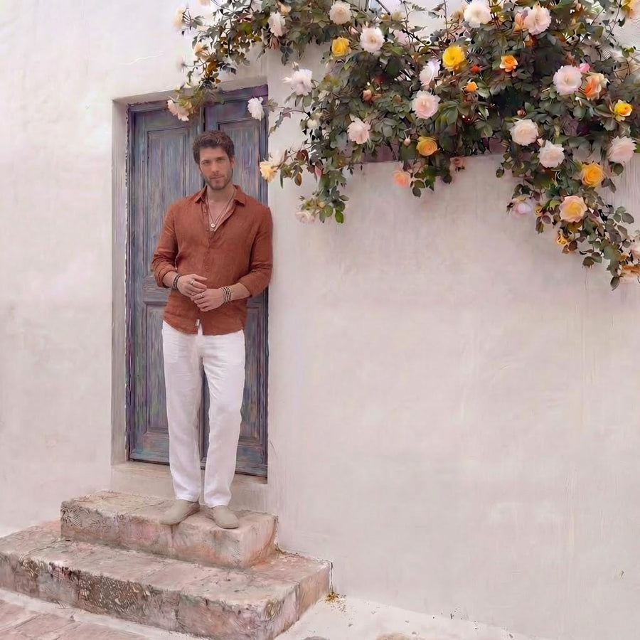 Men's Beach Linen Shirt, Straight Collar: man in Rust Red linen shirt standing on stone steps, hands in pockets