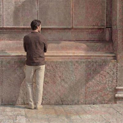 Men's Linen Lace-Up Neck Shirt, Beach: back view of man in Brown linen shirt against a stone wall