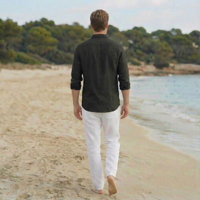 Men's Linen Shirt, Bohemian: back view of man in dark shirt and white trousers on beach