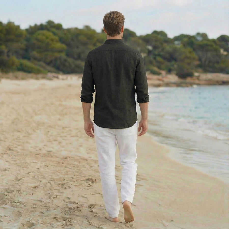 Men's Linen Shirt, Bohemian: back view of man in dark shirt and white trousers on beach