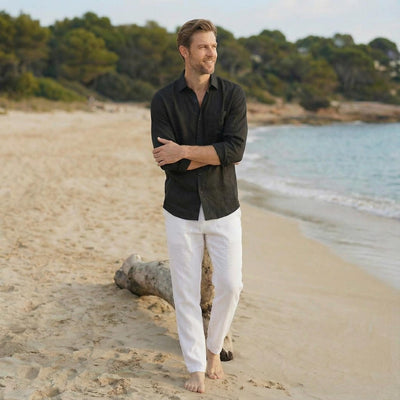 Men's Linen Shirt, Bohemian: man in Black linen shirt with arms crossed, driftwood behind