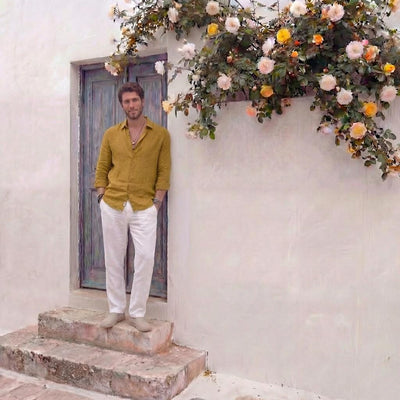 Men's Linen Shirt, Tailored Fit, Custom Length: man in mustard linen shirt and white trousers standing on steps, full length