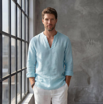 Men's Linen V-Slit Neck Shirt: man in light blue linen v-slit shirt and white trousers by tall windows