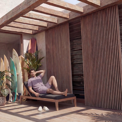 Men's Mandarin Collar Linen Shirt, Relaxed Fit: man reclining on a lounger in dusty mauve shirt and shorts