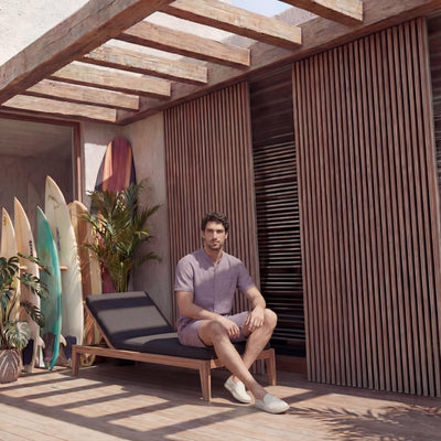 Men's Mandarin Collar Linen Shirt, Relaxed Fit: man seated on a lounger in dusty mauve shirt and shorts
