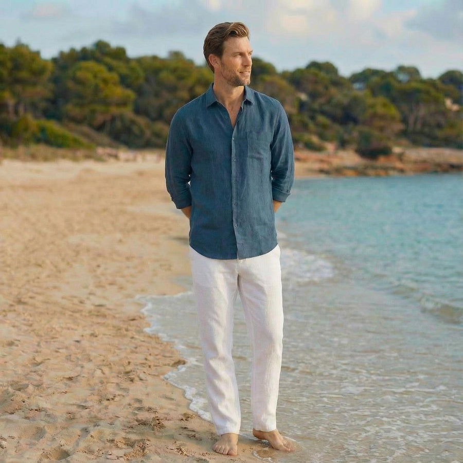 Men's Natural Linen Shirt, Relaxed Fit: man in teal blue relaxed linen shirt, arms at sides, sea behind