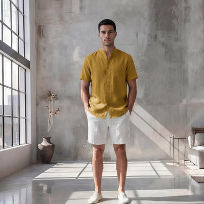 Men's Oversized Short Sleeve Linen Shirt: full length front view of man in mustard shirt and white shorts, arms relaxed