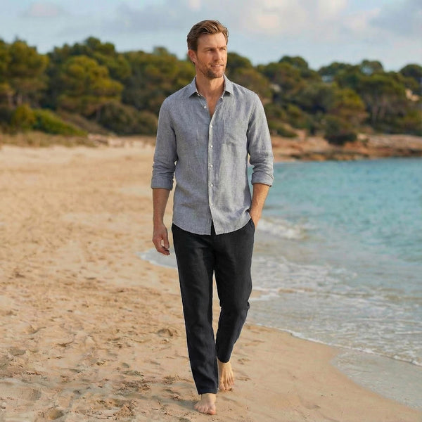 Men's Relaxed Linen Shirt for Daily Wear: man in grey blue linen shirt and dark trousers walking on a beach