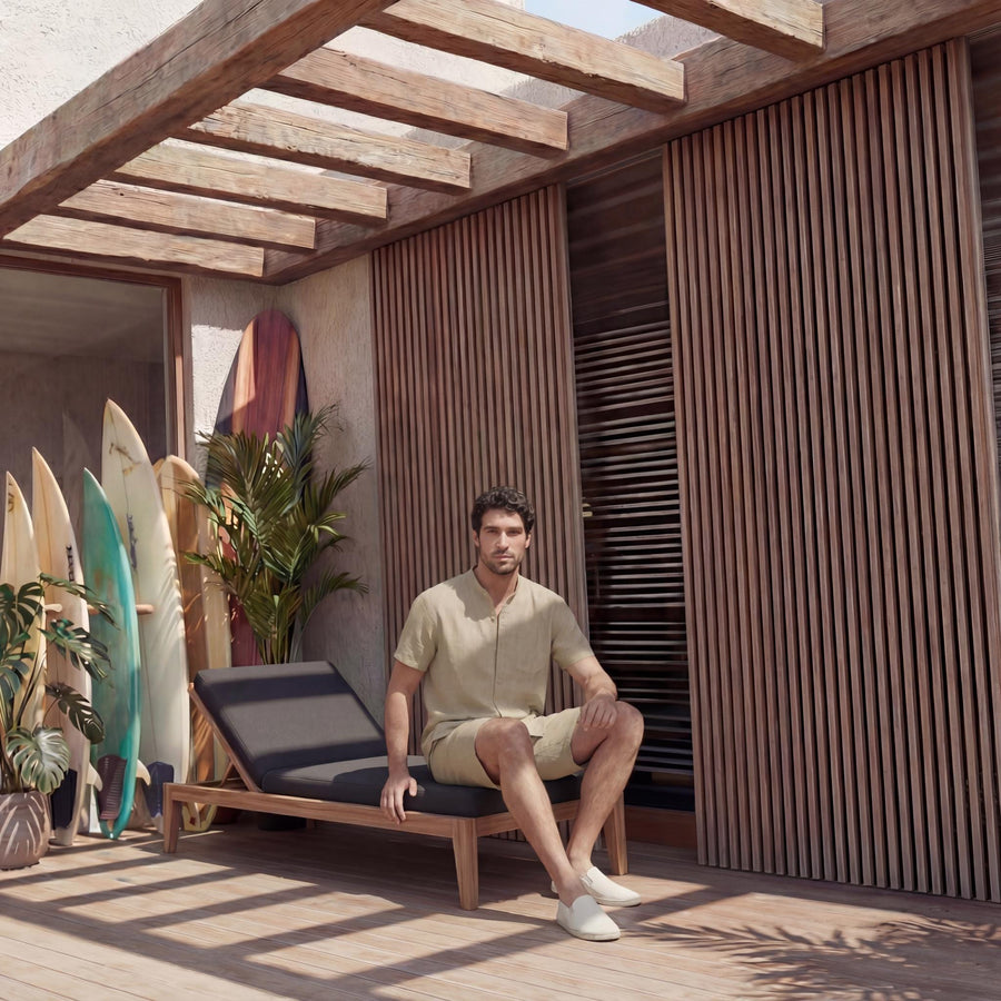 Men's Short Sleeve Linen Shirt, Resort Fit: man seated on the edge of a lounger in Beige shirt and shorts