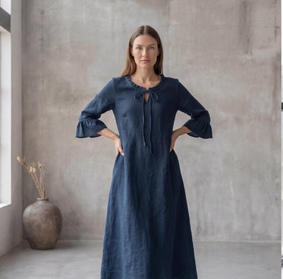 Navy Blue Linen Maxi Dress, Ruffle Neck: woman in Navy Blue linen maxi dress, hands on hips, by a window
