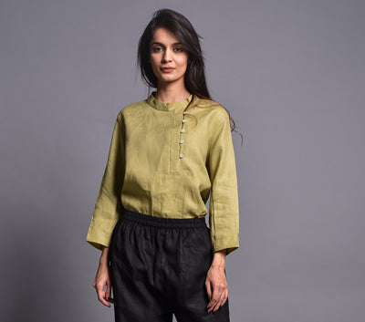 Olive Linen Collared Button Shirt: side angle of woman in olive green linen top with side button placket