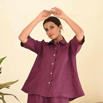 Oversized Linen Shirt, Long Sleeve: woman in Garnet oversized linen shirt with both arms raised over her head