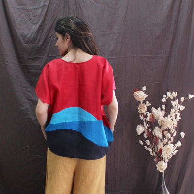 Red Blue Colorblock Linen Top: back view of woman in red and blue colourblock top, mustard trousers