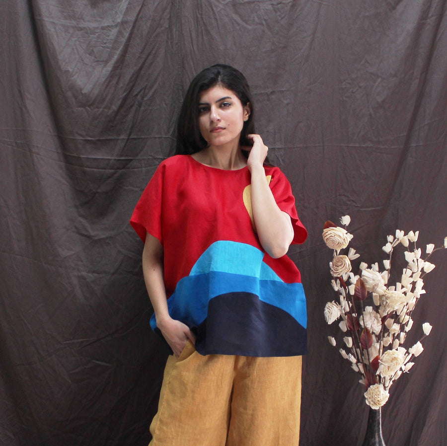 Red Blue Colorblock Linen Top: three-quarter view of colourblock top, hand at collar