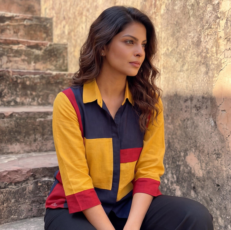 Red Blue Yellow Colorblock Linen Top: close-up of woman seated in colorblock shirt with open collar