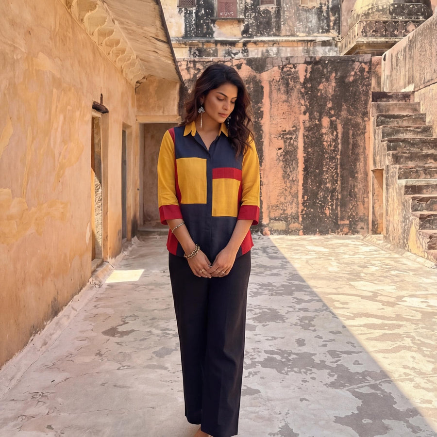 Red Blue Yellow Colorblock Linen Top: full length woman in red, yellow and navy top with black trousers