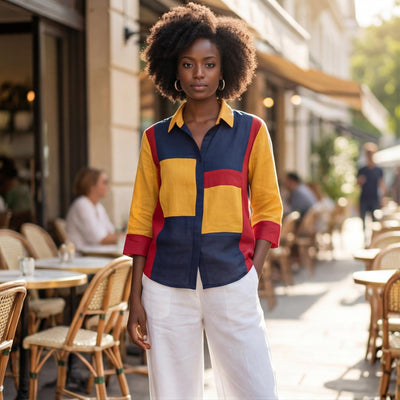 Red Blue Yellow Colorblock Linen Top: woman in colorblock shirt and white trousers at cafe