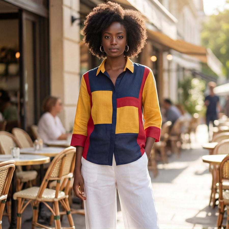 Red Blue Yellow Colorblock Linen Top: woman in colorblock shirt and white trousers at cafe