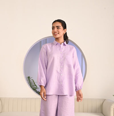 Relaxed Fit Linen Shirt, Elastic Cuff: woman in Lavender linen shirt and wide leg trousers standing by a round mirror