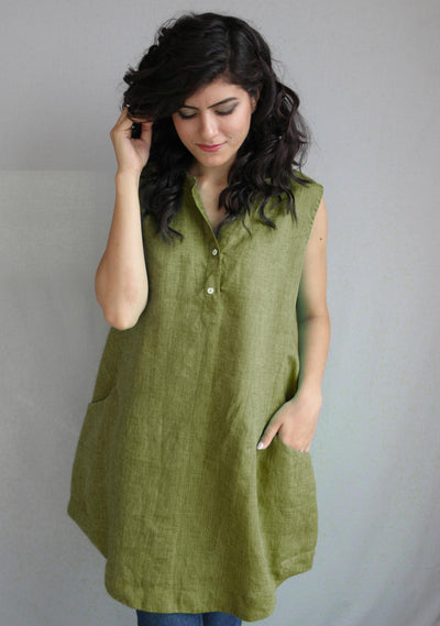Sleeveless Linen Mini Dress with Pockets: close-up of woman in green sleeveless linen mini dress, hand in hair
