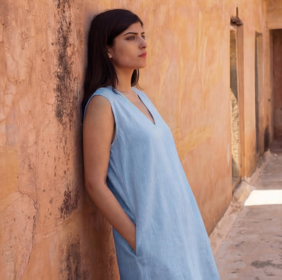 Sleeveless Linen Mini Dress, Relaxed Fit: woman in light blue mini dress leaning on wall, V neckline