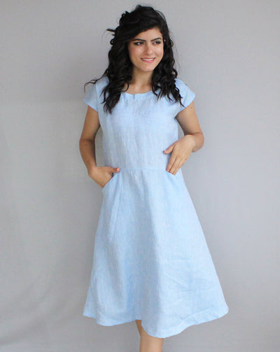 Washed Linen Tunic Dress with Pockets: woman in Ice Blue linen tunic dress, hand in pocket, studio backdrop